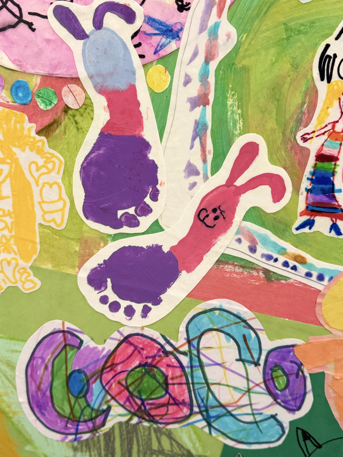 Close-up of a collage with a painted footprint and the kid's name in crayon