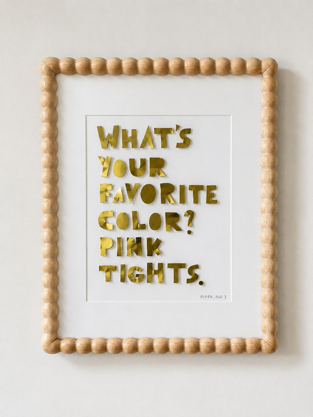 Quote piece in a beaded wood natural frame, gold metal letters on cream cardstock
