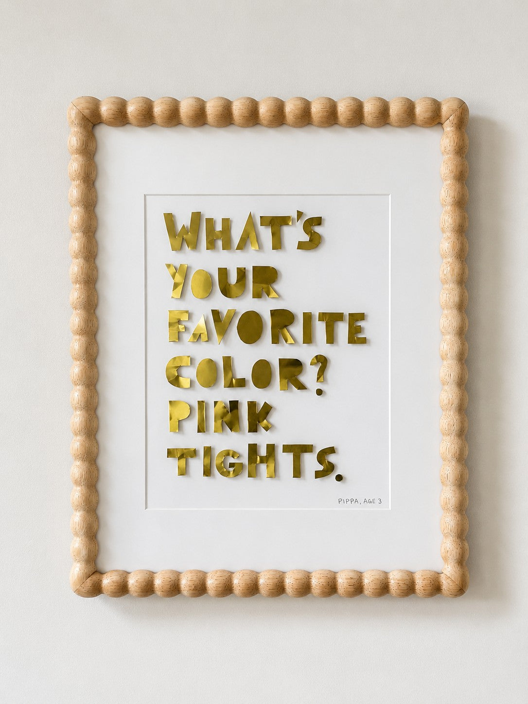Quote piece in a beaded wood natural frame, gold metal letters on cream cardstock